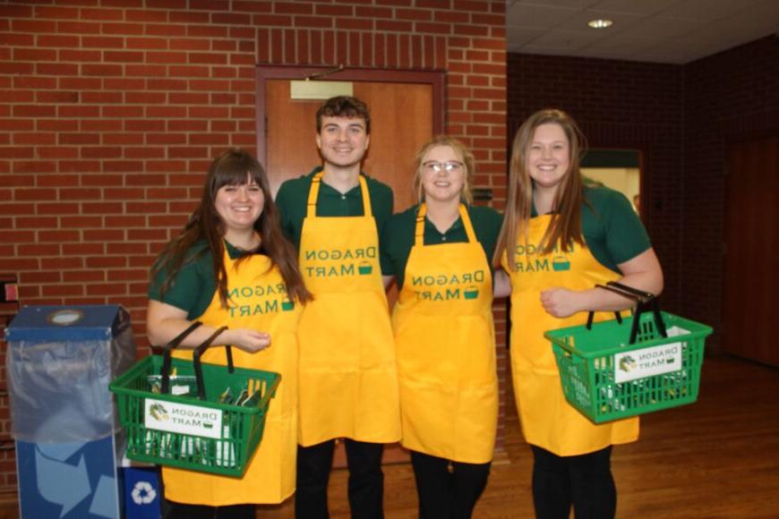 four college students with dragon mart aprons